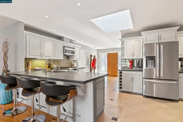 a kitchen with stainless steel appliances a sink and a refrigerator