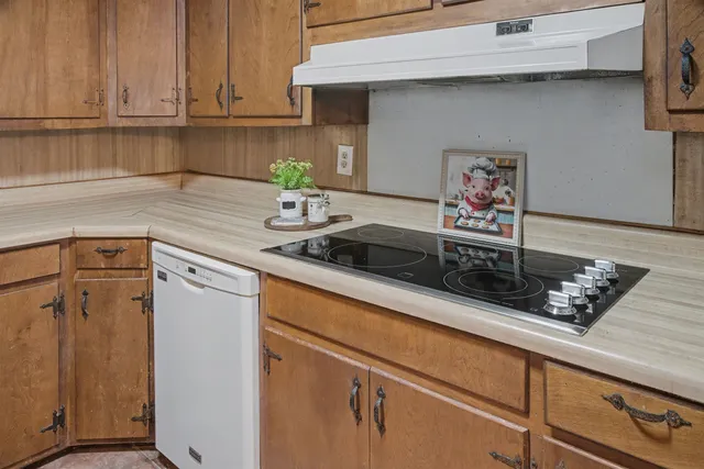 a kitchen with stainless steel appliances granite countertop a sink a stove and cabinets