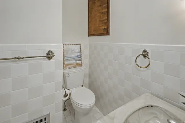 a bathroom with a granite countertop toilet a sink and shower