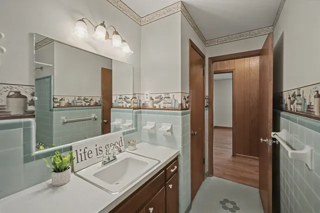 a bathroom with a sink vanity granite tub and shower