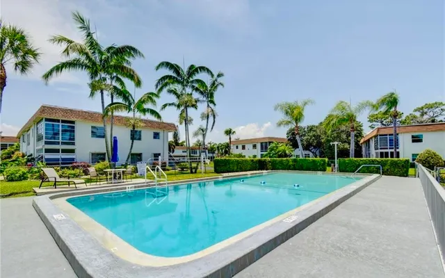 a view of an house with swimming pool and a porch