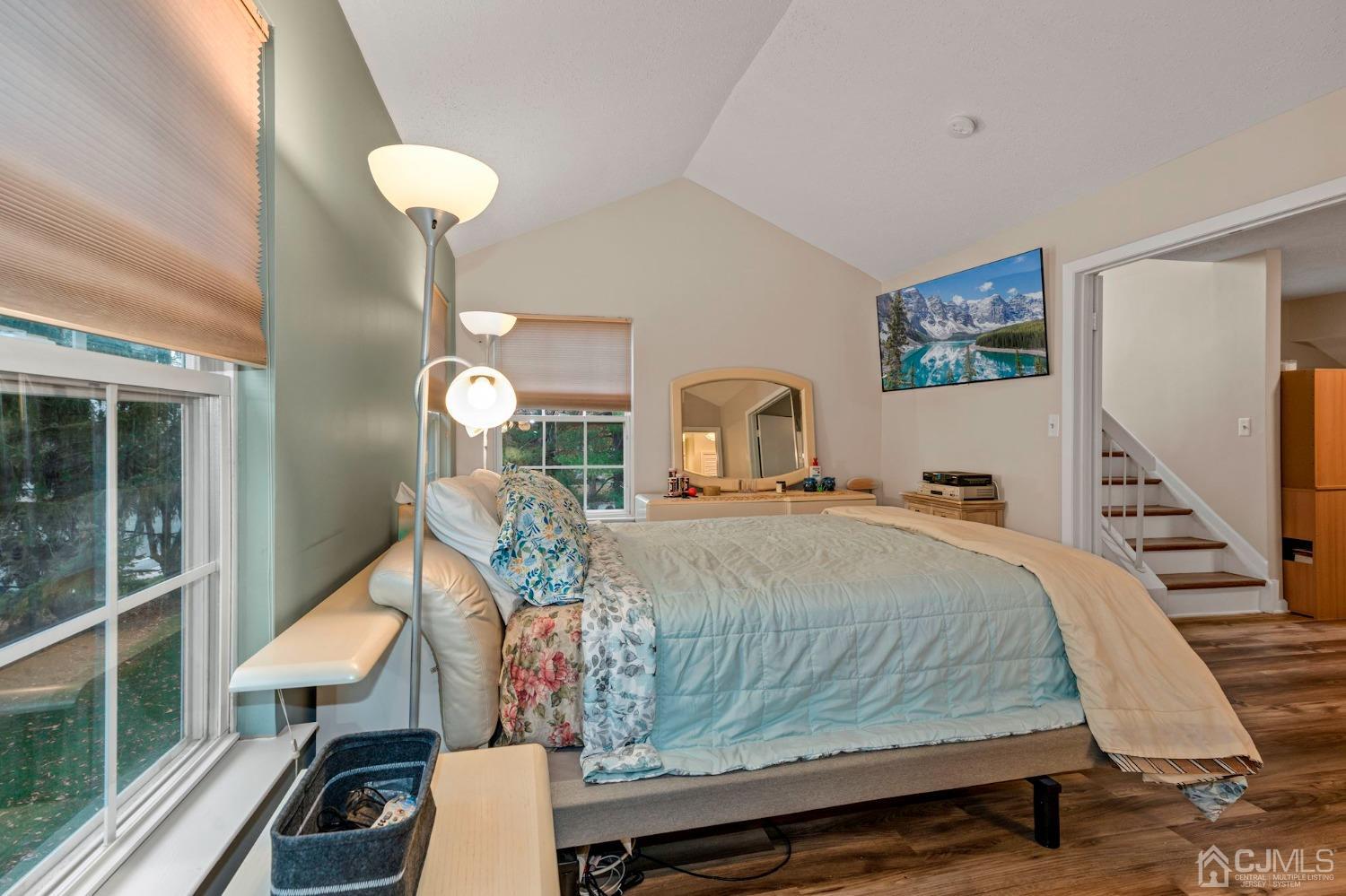 58 Nova Drive Piscataway, NJ 08854 - Photo 12 of 16 a bedroom with a bed a mirror and lamp on table