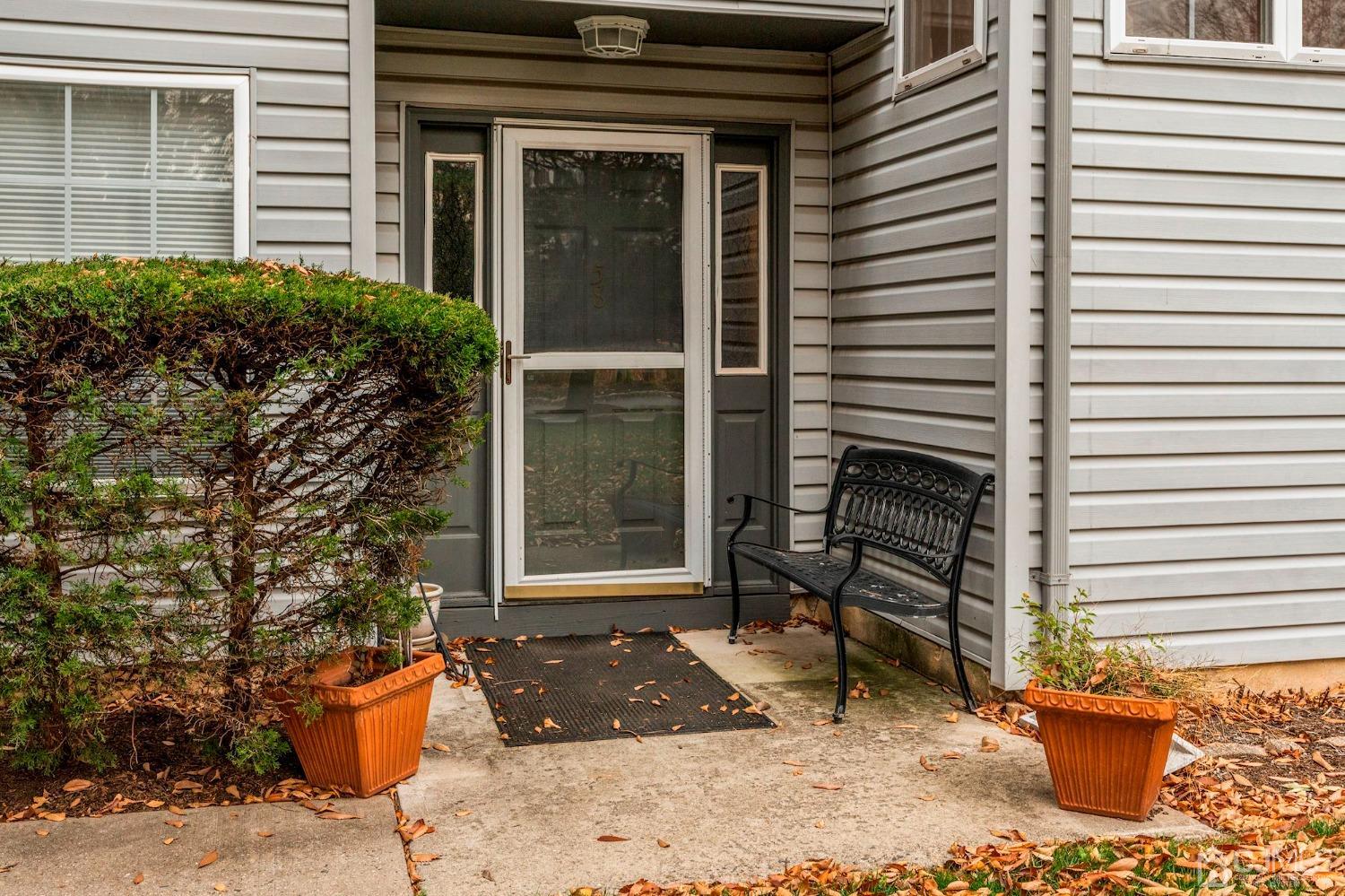 58 Nova Drive Piscataway, NJ 08854 - Photo 16 of 16 a view of a door with a chair and potted plants