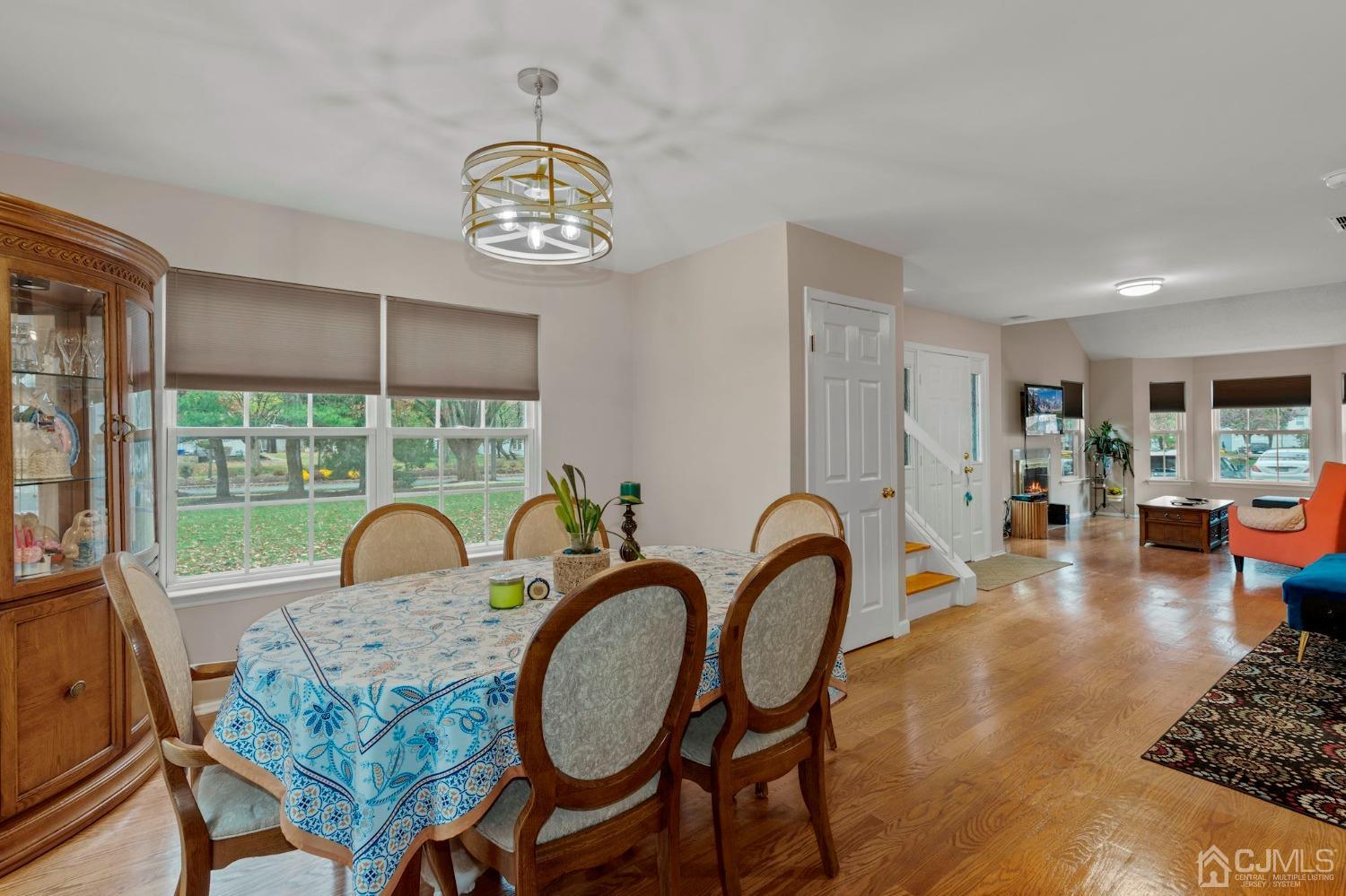 58 Nova Drive Piscataway, NJ 08854 - Photo 6 of 16 a view of a dining room with furniture a chandelier and wooden floor