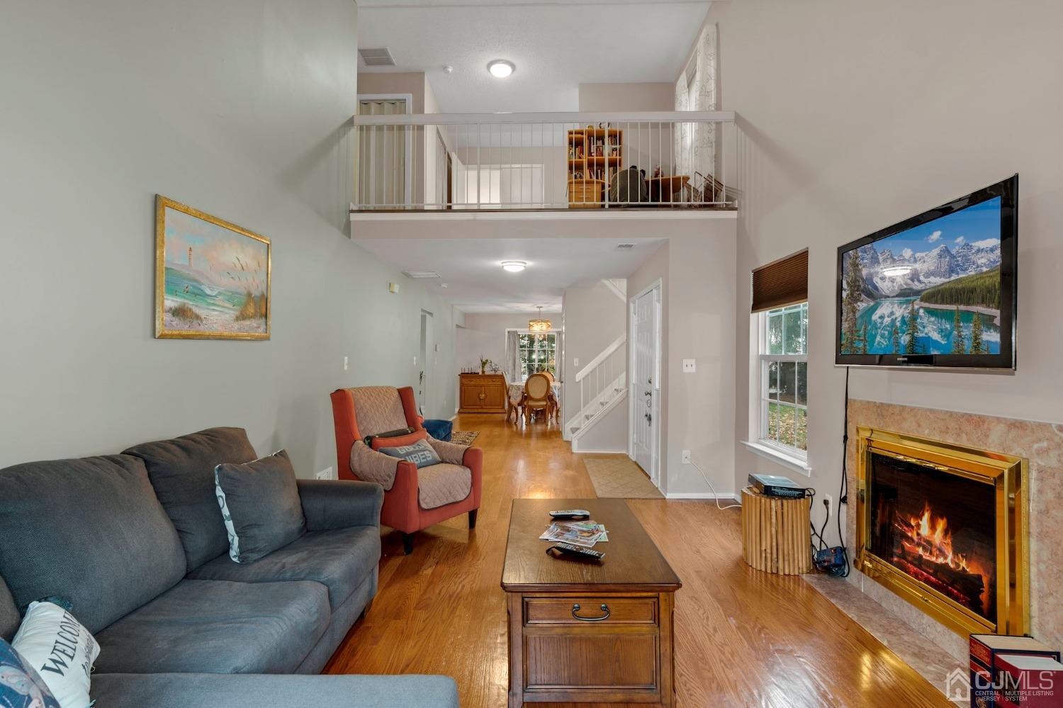 58 Nova Drive Piscataway, NJ 08854 - Photo 7 of 16 a living room with furniture a flat screen tv and a fireplace