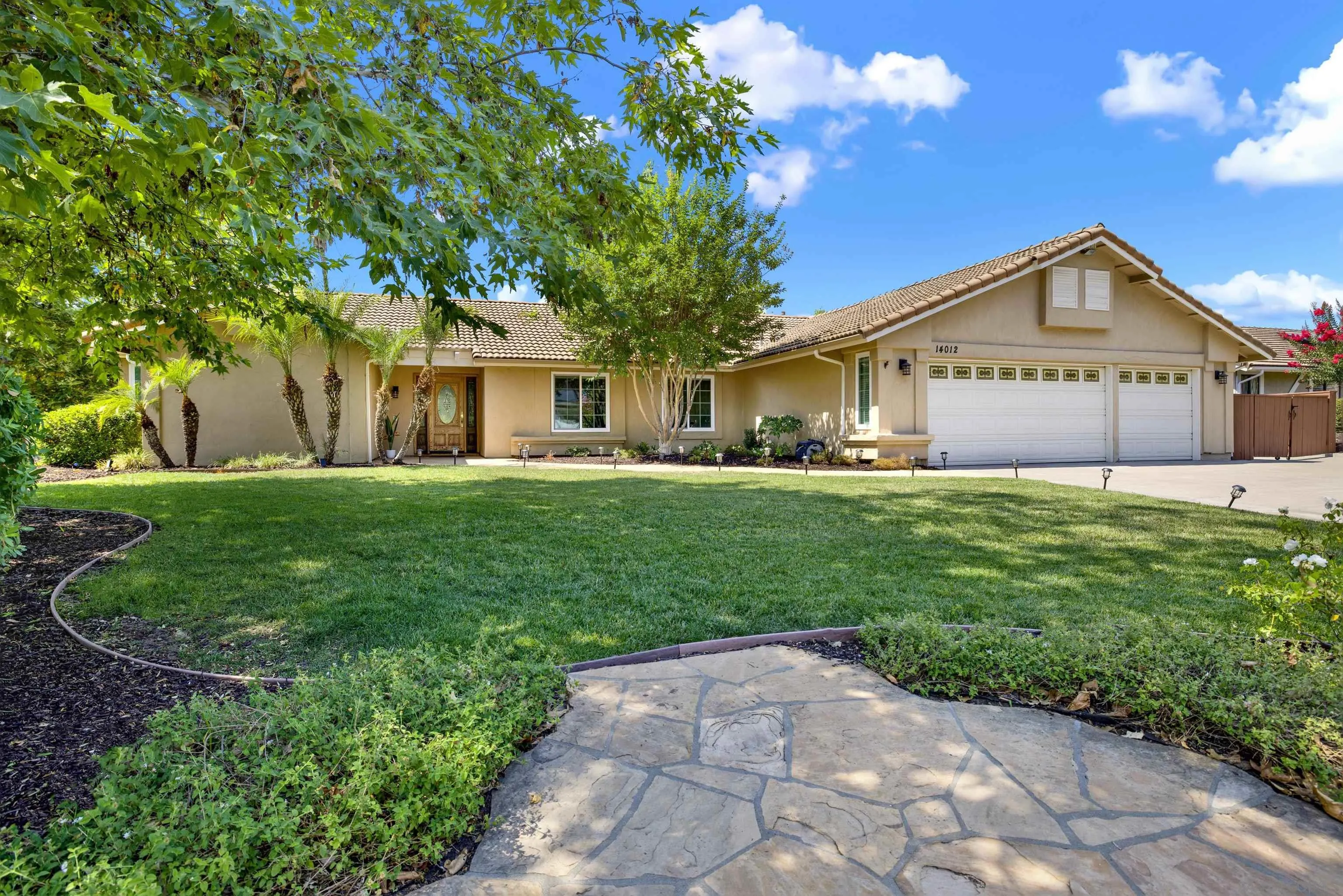 14012 Valley Springs Road Poway, CA 92064 - Photo 1 of 57 a front view of a house with a yard and trees