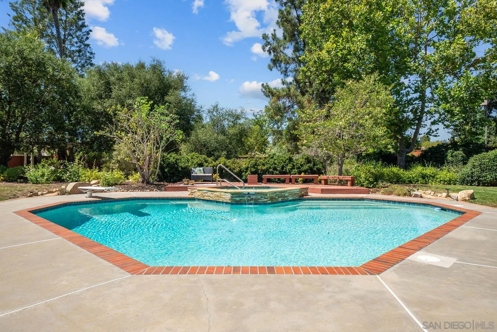 14012 Valley Springs Road Poway, CA 92064 - Photo 40 of 57 a view of a swimming pool with an outdoor seating and a yard
