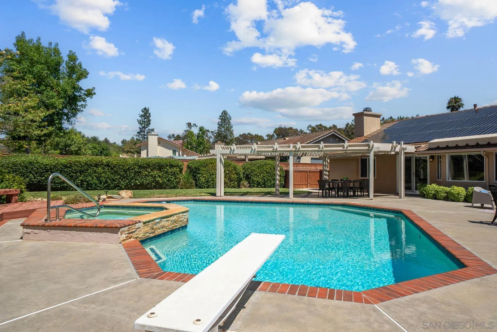 14012 Valley Springs Road Poway, CA 92064 - Photo 42 of 57 a view of a swimming pool with lounge chairs in patio