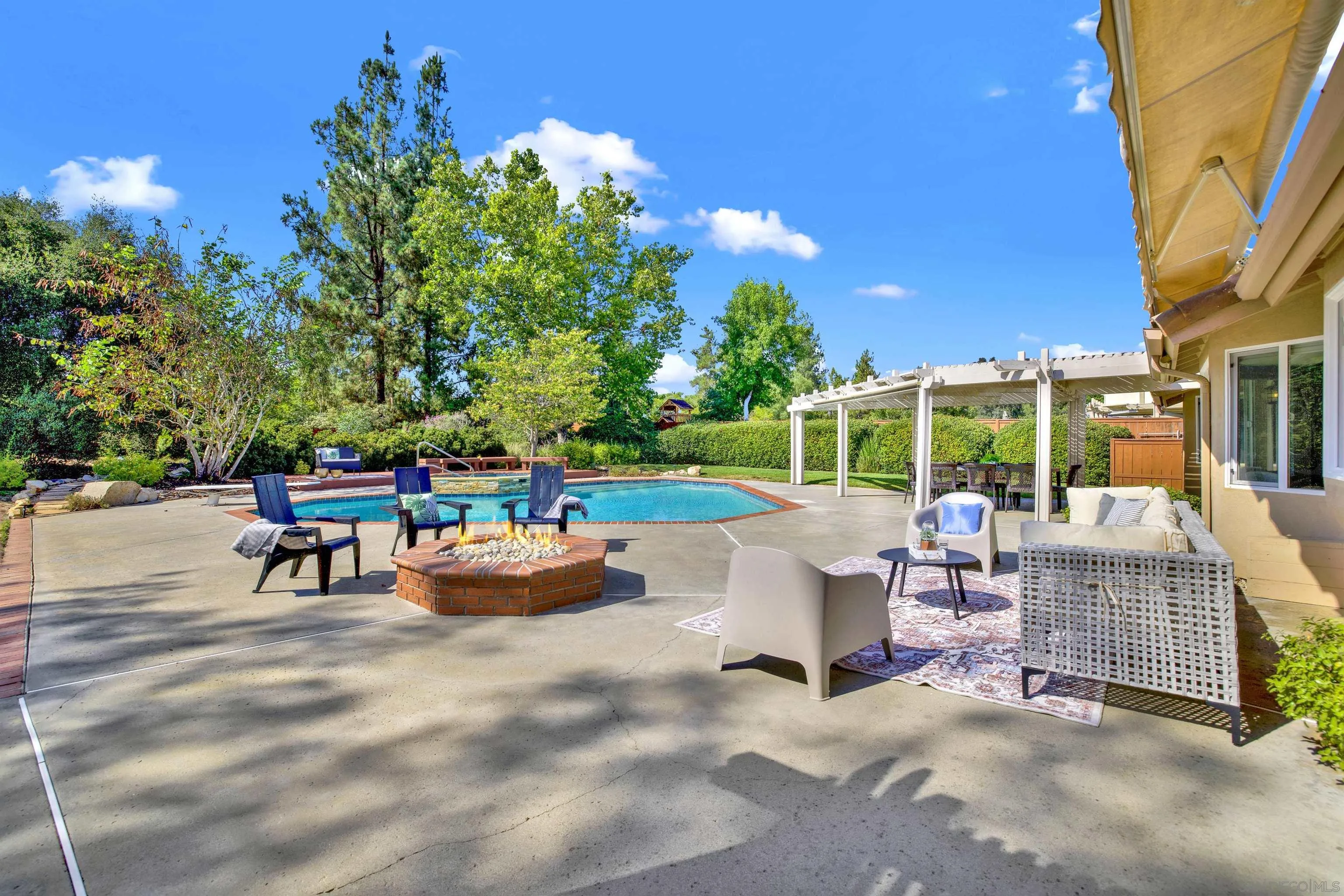14012 Valley Springs Road Poway, CA 92064 - Photo 47 of 57 a view of a patio with couches and table and chairs and floor to ceiling window