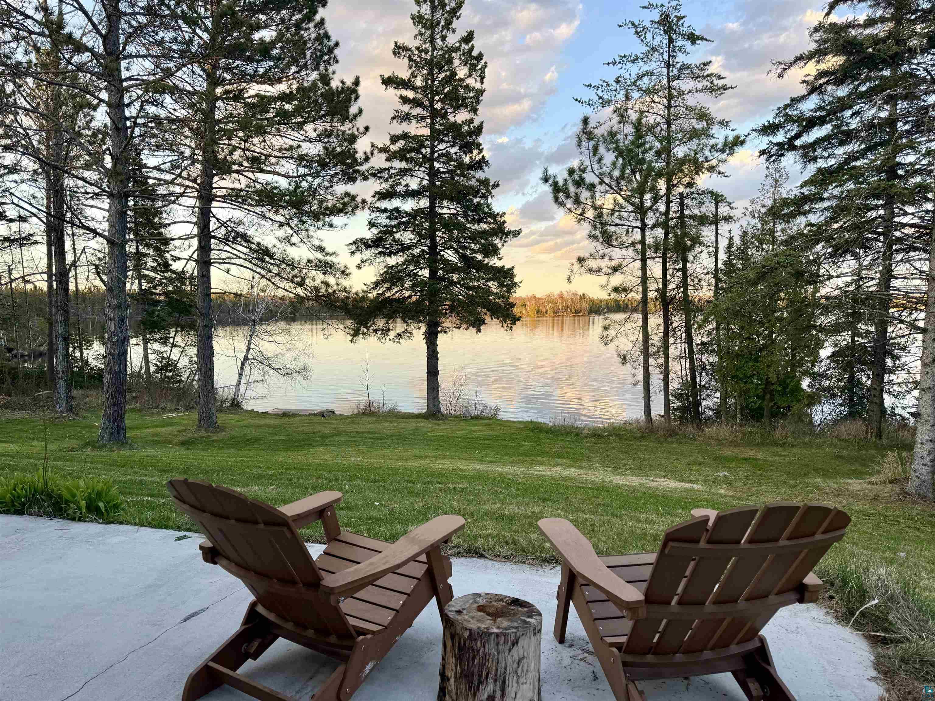 5274 Marble Lake Road Two Harbors, MN 55616 - Photo 35 of 79 Expansive lake frontage with a manicured lawn framed by mature evergreen trees
