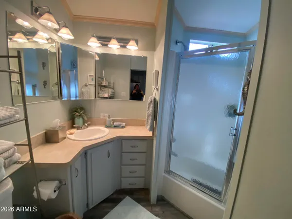 a bathroom with a double vanity sink mirror and shower