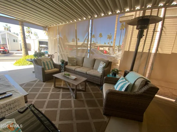 a living room with patio furniture and a fireplace