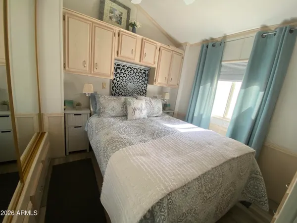 a bedroom with a bed and a mirror