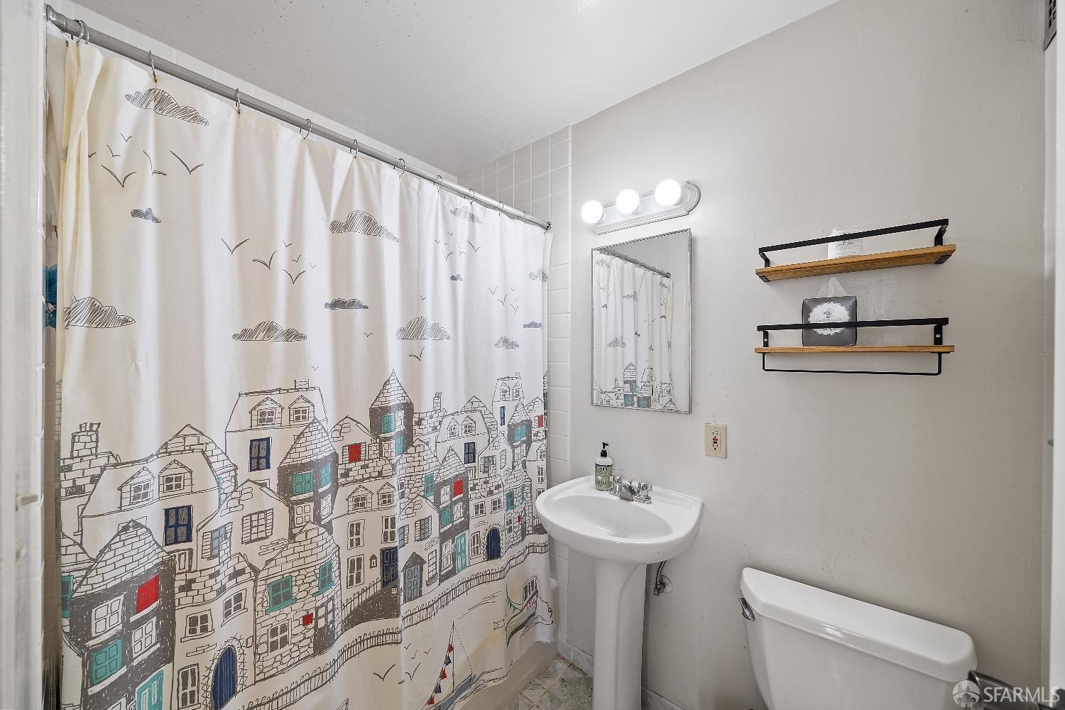30 Quickstep Lane, Unit 3 San Francisco, CA 94115 - Photo 11 of 20 a bathroom with a sink a toilet and shower curtain