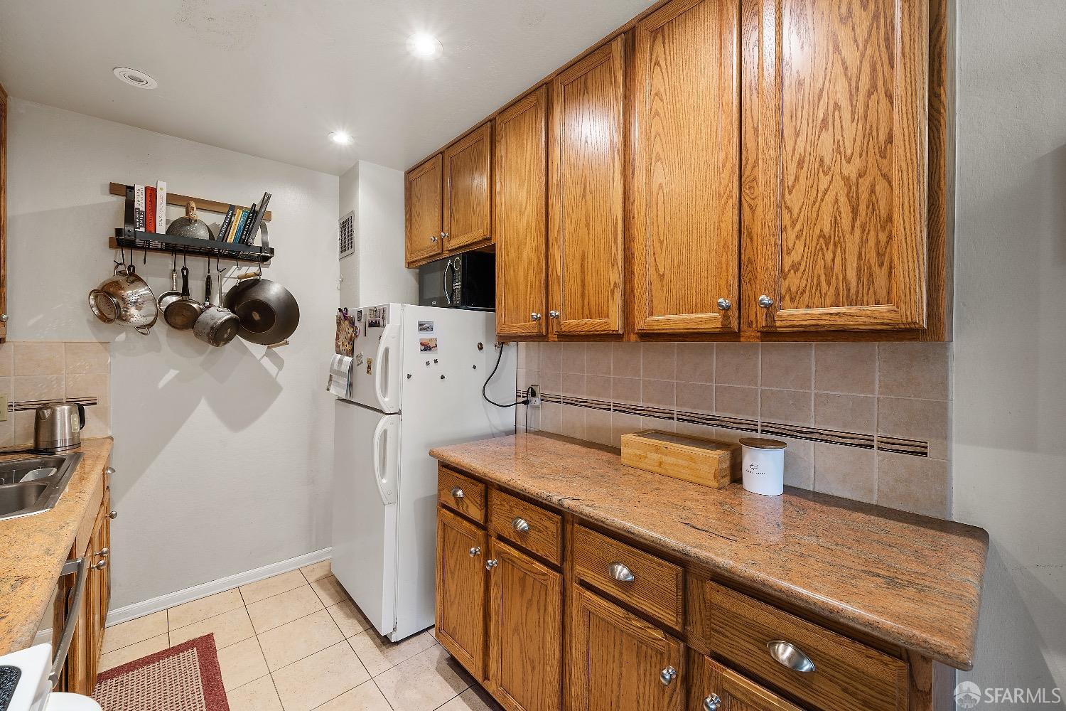30 Quickstep Lane, Unit 3 San Francisco, CA 94115 - Photo 6 of 20 a kitchen with a sink cabinets and appliances
