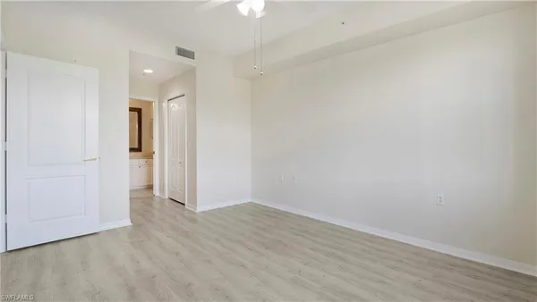 a view of an empty room with wooden floor