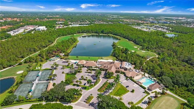 an aerial view of residential houses with outdoor space and trees
