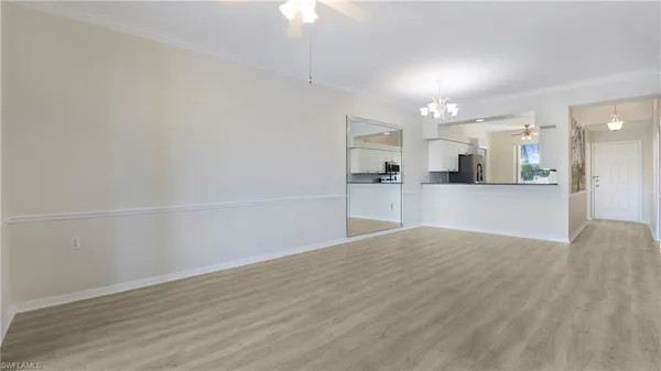 a view of a kitchen with wooden floor and a kitchen