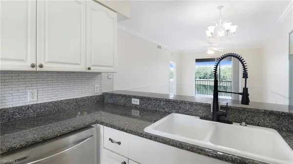 a bathroom with a granite countertop sink a large mirror and vanity