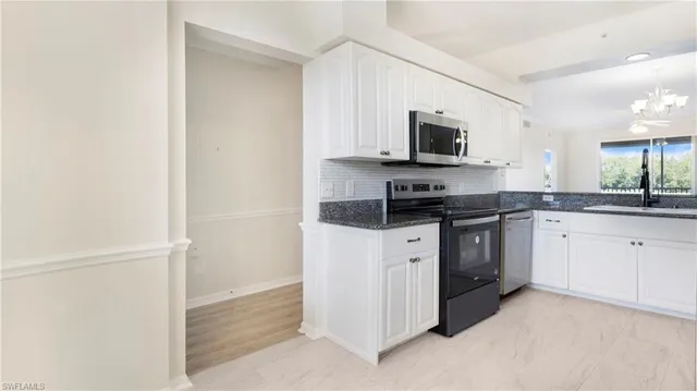 a kitchen with a refrigerator and a stove top oven