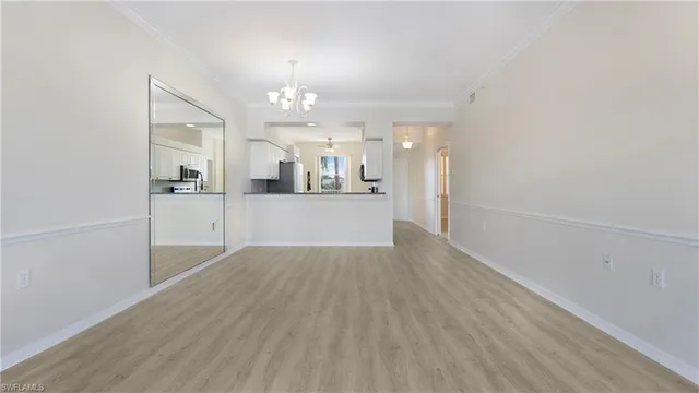 wooden floor in an empty room with a kitchen