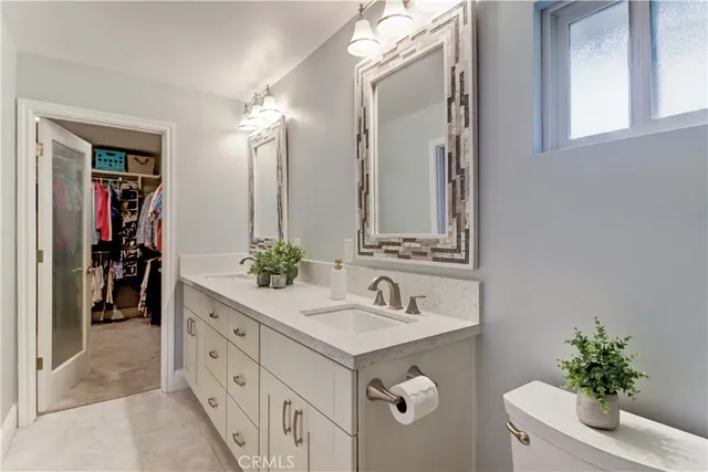 a bathroom with a sink double vanity and a mirror