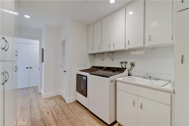 a view of a kitchen with sink and cabinets