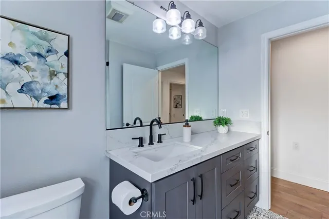 a bathroom with a sink a toilet and a mirror