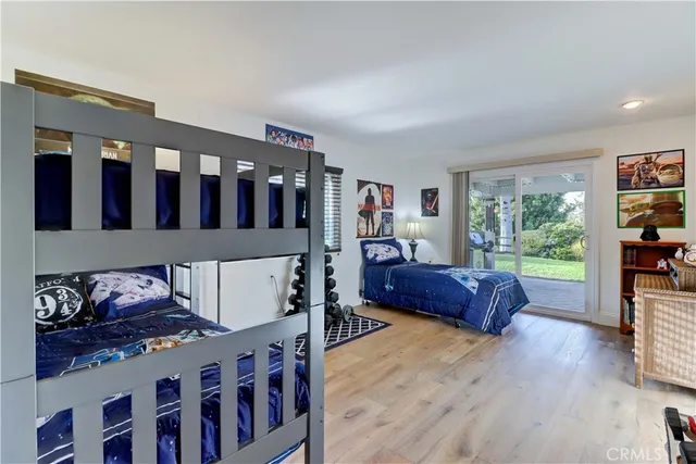 a bedroom with furniture and a large window