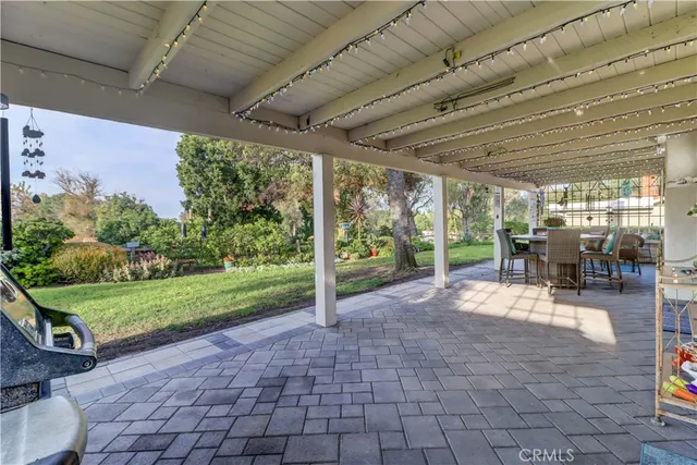 a view of a patio with table and chairs potted plants with wooden floor