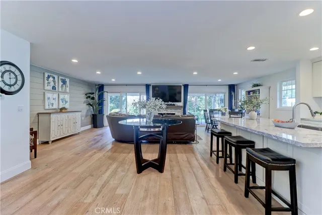 a living room with stainless steel appliances kitchen island granite countertop furniture and a kitchen view