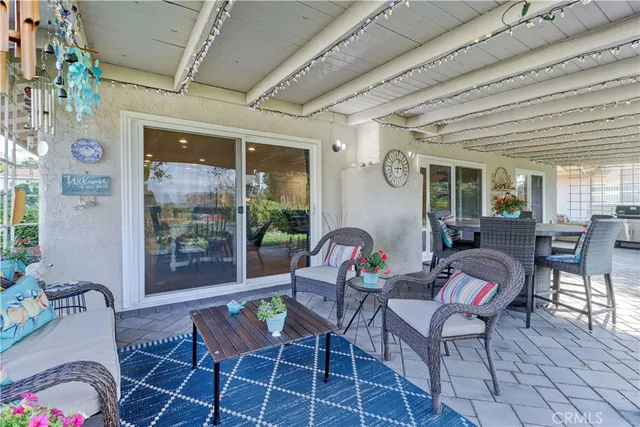 a building outdoor space with patio furniture and potted plants