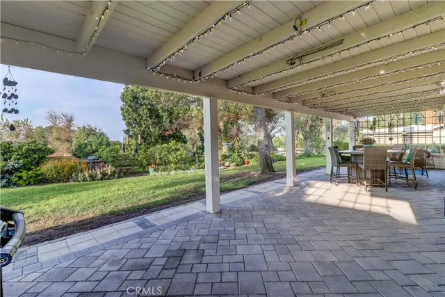 a view of a porch with chairs and backyard