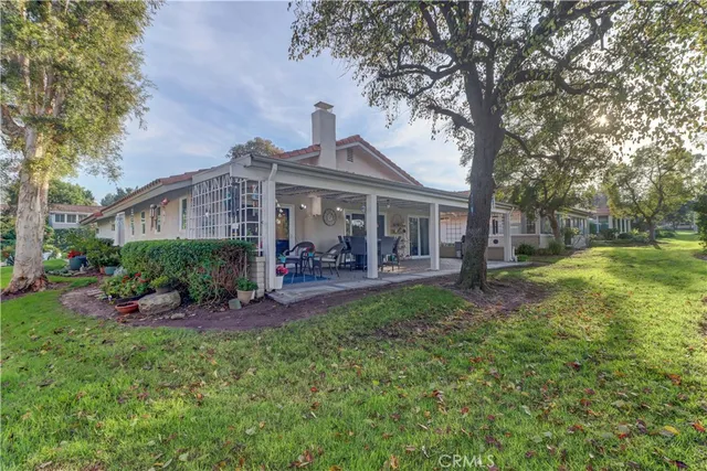 a view of a house with a yard porch and sitting area