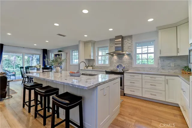 a kitchen with counter top space appliances and windows