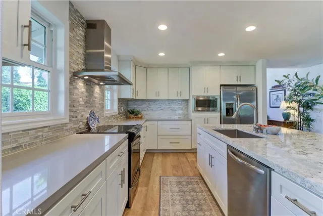 a kitchen with a sink stove and cabinets