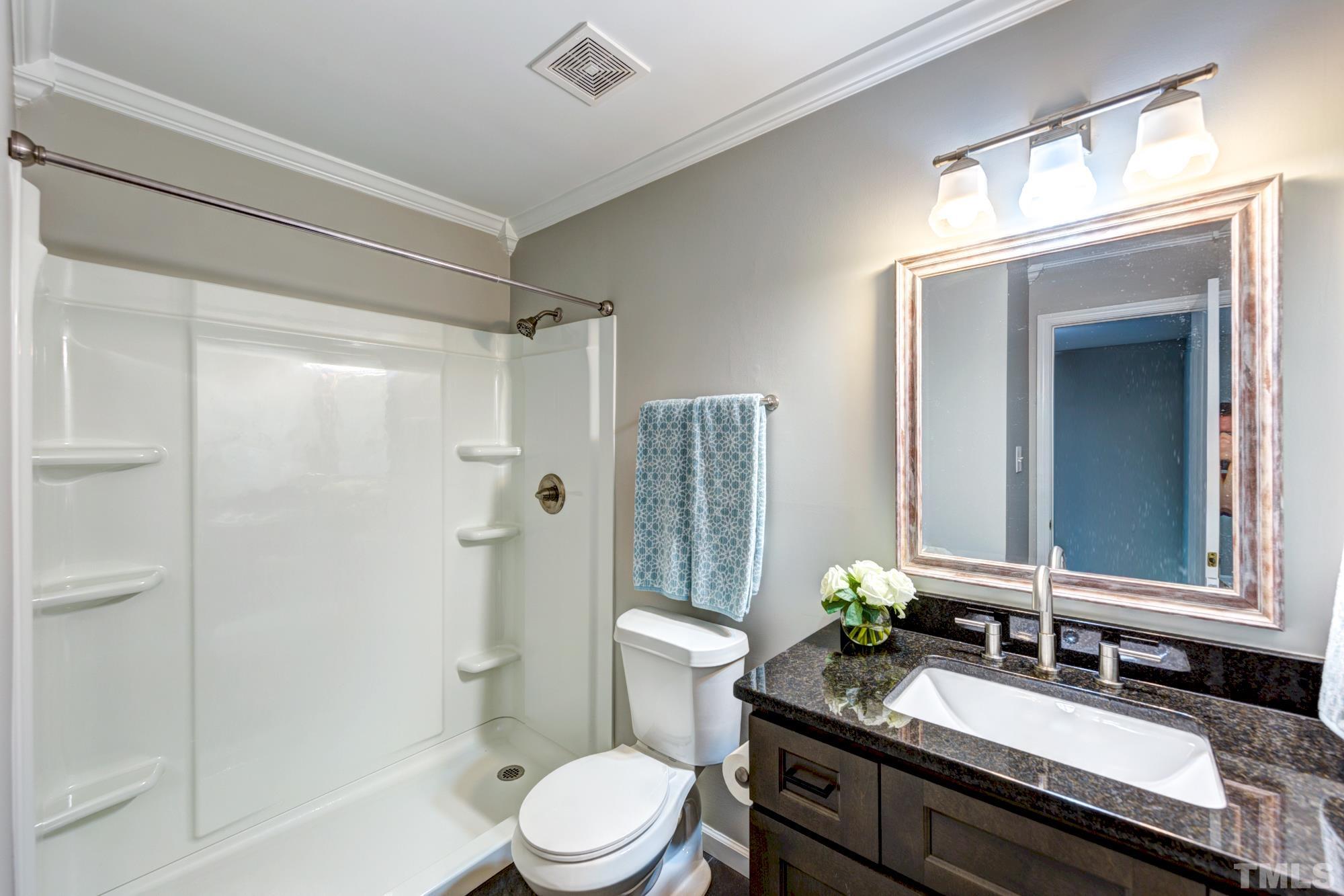 3623 Mill Run, Unit 3623 Raleigh, NC 27612 - Photo 19 of 23 a bathroom with a granite countertop sink toilet a large mirror a shower and a bathtub