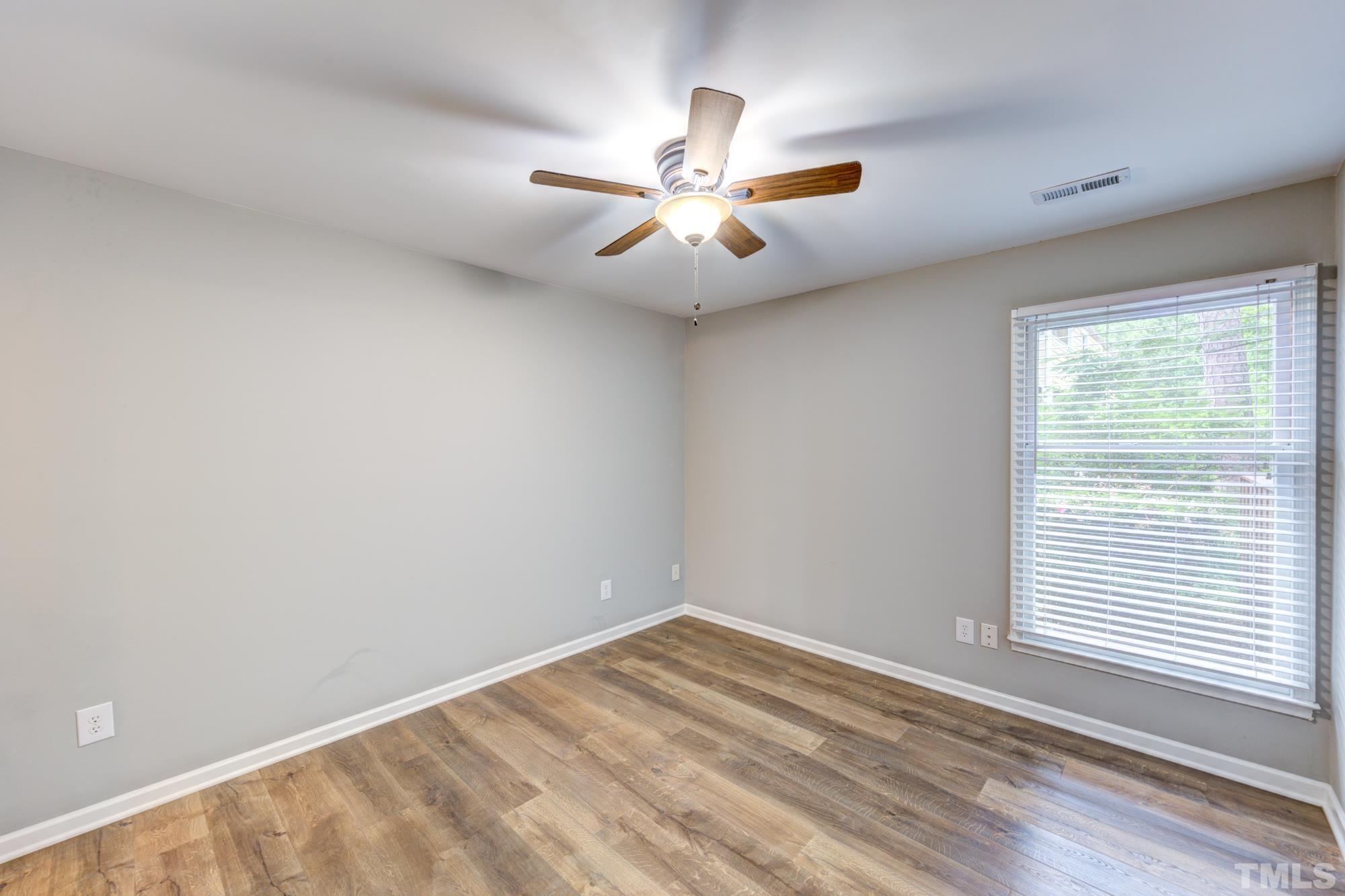 3623 Mill Run, Unit 3623 Raleigh, NC 27612 - Photo 20 of 23 an empty room with a window and ceiling fan