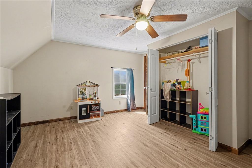 2986 Defore Road Toccoa, GA 30577 - Photo 14 of 19 an empty room with wooden floor and a ceiling fan