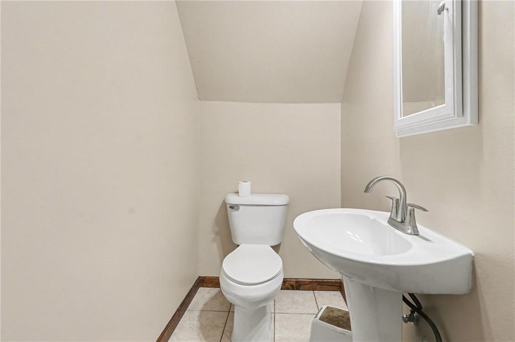 2986 Defore Road Toccoa, GA 30577 - Photo 16 of 19 a bathroom with a toilet a sink and mirror