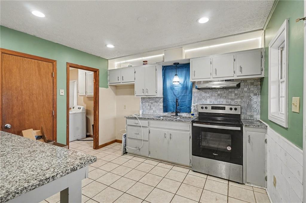 2986 Defore Road Toccoa, GA 30577 - Photo 3 of 19 a kitchen with stainless steel appliances granite countertop a stove a sink and a refrigerator