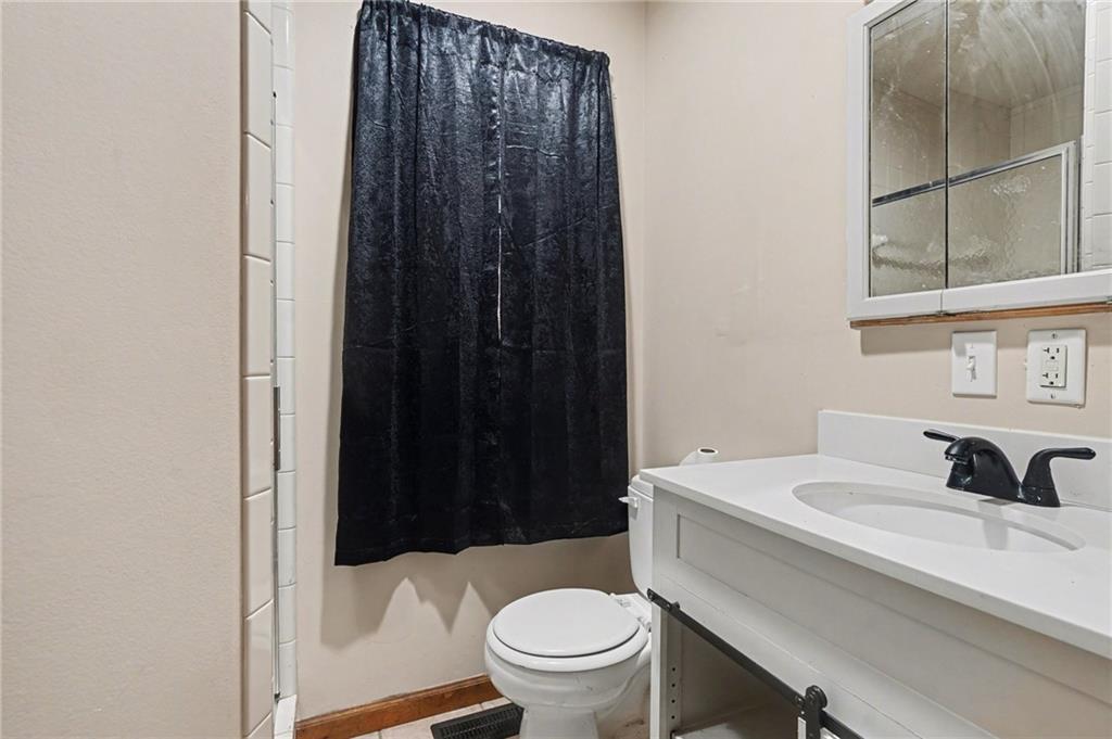2986 Defore Road Toccoa, GA 30577 - Photo 10 of 19 a bathroom with a sink a toilet a shower and a mirror