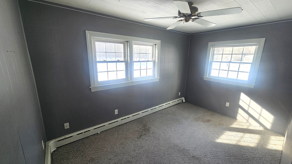 58 Ruggles Street Hardwick, MA 01031 - Photo 11 of 20 an empty room with windows and fan