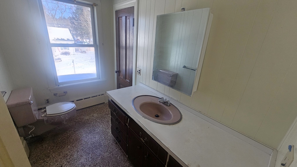 58 Ruggles Street Hardwick, MA 01031 - Photo 16 of 20 a bathroom with a granite countertop sink a toilet and a window