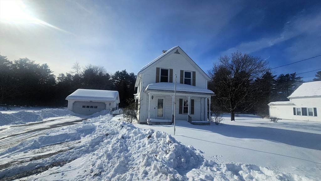 58 Ruggles Street Hardwick, MA 01031 - Photo 2 of 20 a front view of a house with a yard and garage