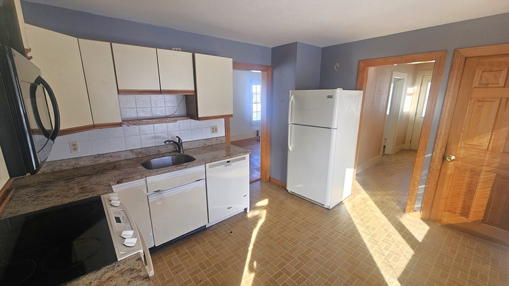 58 Ruggles Street Hardwick, MA 01031 - Photo 6 of 20 a kitchen with white cabinets and refrigerator