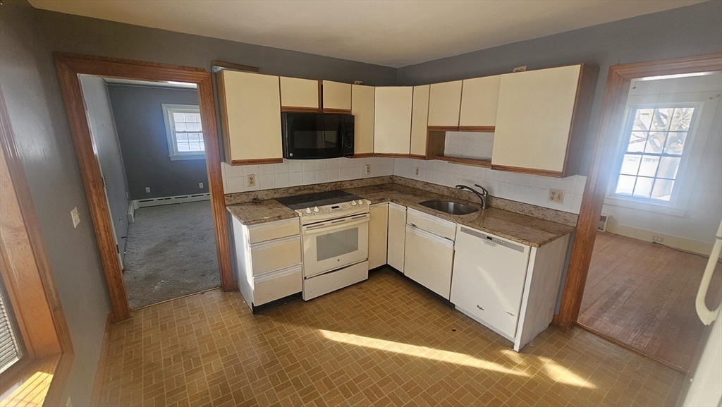 58 Ruggles Street Hardwick, MA 01031 - Photo 7 of 20 a kitchen with white cabinets sink and stove