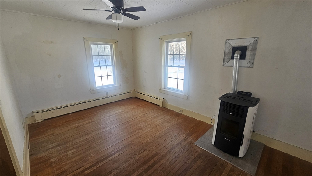 58 Ruggles Street Hardwick, MA 01031 - Photo 9 of 20 a view of an empty room with a window and wooden floor
