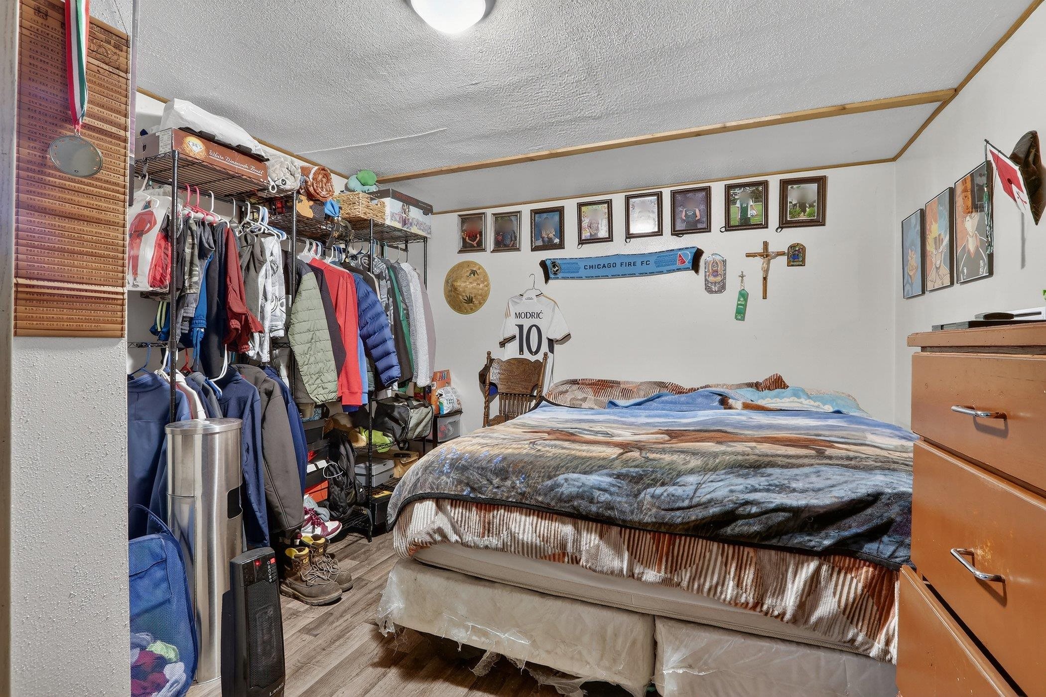 14858 Beaverton Road Poplar Grove, IL 61065 - Photo 25 of 45 a view of walk in closet with clothes and shoes