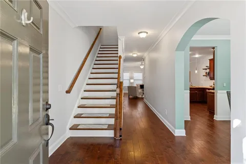 a view of a hallway with wooden floor and entryway